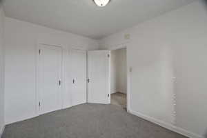 Unfurnished bedroom with carpet floors and a closet