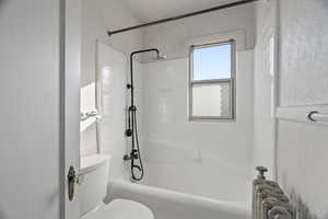 Full bathroom with  shower combination and toilet