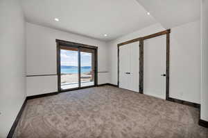 Unfurnished bedroom with carpet floors, access to outside, and recessed lighting