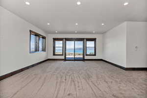 Empty room featuring light carpet and recessed lighting