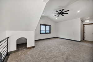 Additional living space with carpet, a ceiling fan, lofted ceiling, and recessed lighting