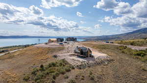 Aerial view of property and surrounding area featuring a water and mountain view
