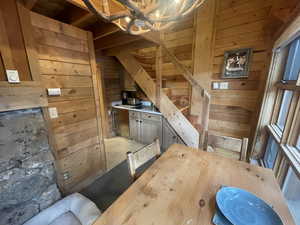 Dining space featuring wooden walls and light tile patterned flooring