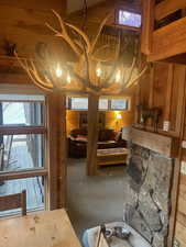 Interior space featuring wooden walls, carpet, and a high ceiling