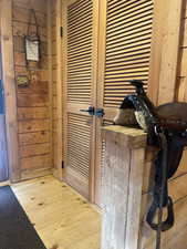 Detailed view of wood finished floors and wooden walls