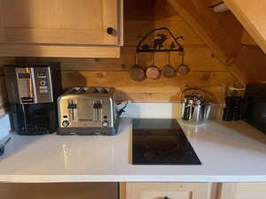 Kitchen view of black appliances and light stone counters