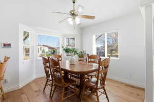 Dining area featuring light wood-style floors and a ceiling fan