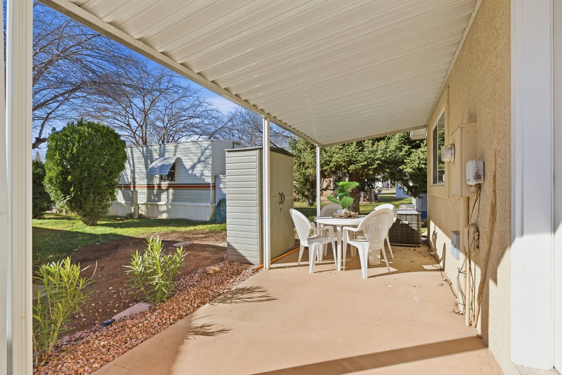 View of patio featuring outdoor dining space and a shed