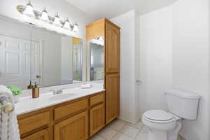 Full bath with vanity and light tile patterned floors