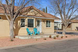 View of front of home featuring stucco siding and a tiled roof