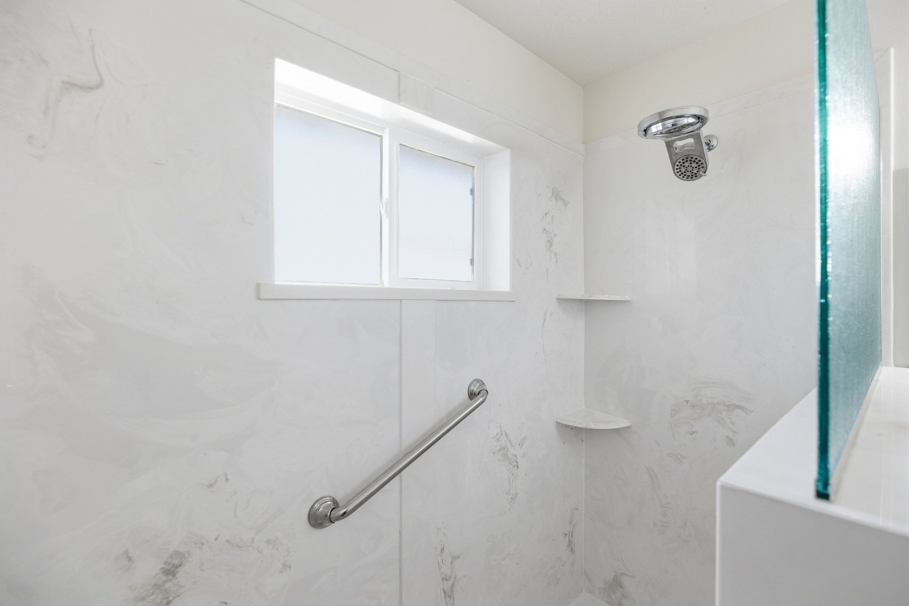 Bathroom with a marble finish shower