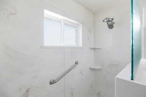 Bathroom with a marble finish shower