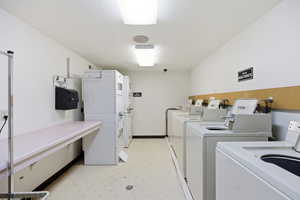 Communal laundry room with separate washer and dryer