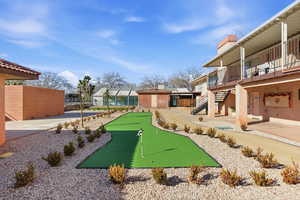 Surrounding community with an area to practice putting and a balcony