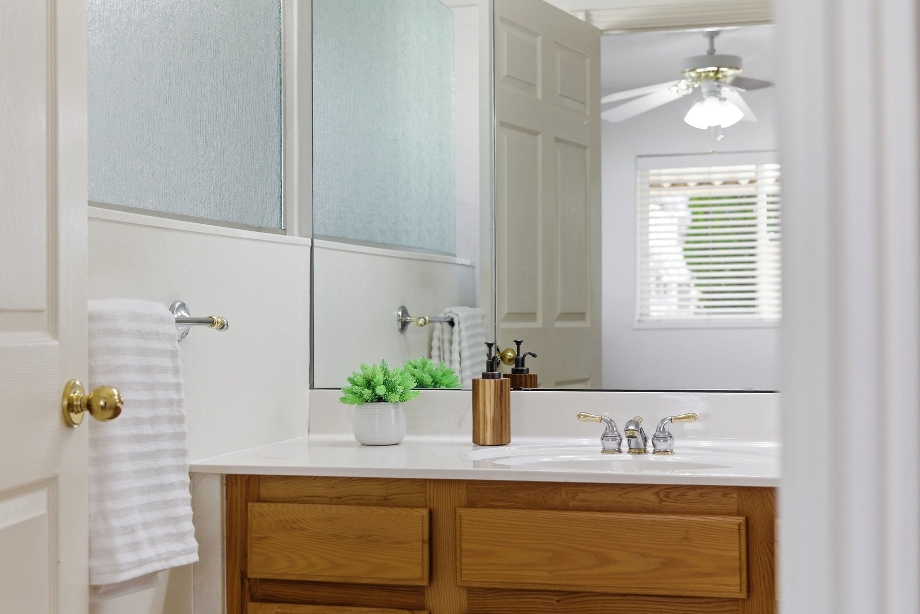 Bathroom featuring vanity and ceiling fan