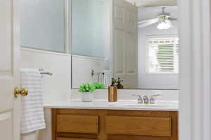 Bathroom featuring vanity and ceiling fan