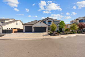 Modern inspired farmhouse featuring a residential view, an attached garage, board and batten siding, driveway, and a gate