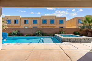 Relaxing pool / spa featuring a patio area and a fenced backyard