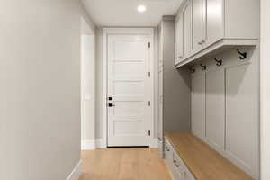 Mudroom with light wood-type flooring and recessed lighting