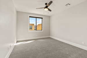 Spare room featuring carpet floors and a ceiling fan