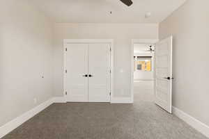 Unfurnished bedroom with carpet floors, a closet, and ceiling fan