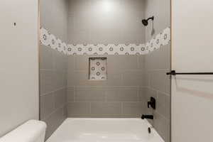 Full bath featuring toilet and shower / bath combination