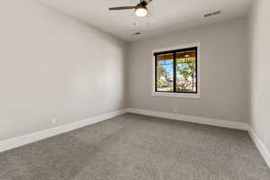 Spare room with light carpet and a ceiling fan