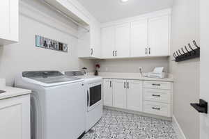 Laundry area featuring cabinet space and washing machine and clothes dryer