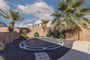 Fenced backyard with a trampoline