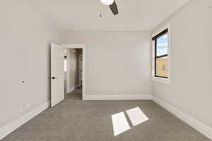Unfurnished bedroom featuring light carpet and a ceiling fan