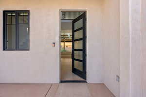 Entrance to property featuring stucco siding