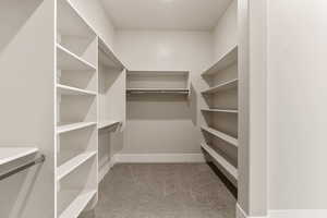 Walk in closet with light carpet