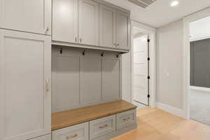 Mudroom featuring light wood finished floors and recessed lighting