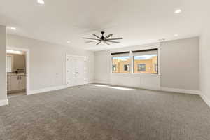 Unfurnished bedroom featuring carpet floors, a ceiling fan, recessed lighting, and ensuite bathroom