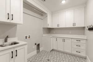 Laundry room featuring hookup for a washing machine, cabinet space, and electric dryer hookup