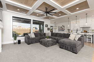 Living area featuring coffered ceiling, recessed lighting, a ceiling fan, and a fireplace
