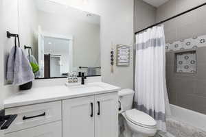 Bathroom featuring shower / bathtub combination with curtain and vanity