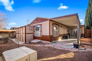 Fenced back yard with workshop area and patio