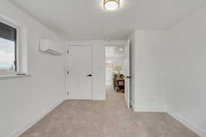 Unfurnished bedroom featuring baseboards and light colored carpet