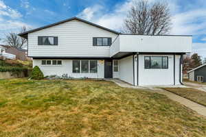 View of front of home featuring a front lawn and brick siding