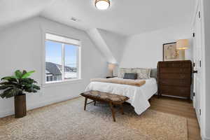 Bedroom featuring a textured ceiling and light wood finished floors