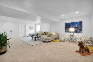 Carpeted living area featuring recessed lighting