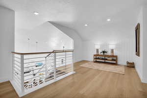 Additional living space featuring light wood finished floors and recessed lighting