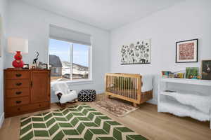 Bedroom featuring light wood finished floors and baseboards