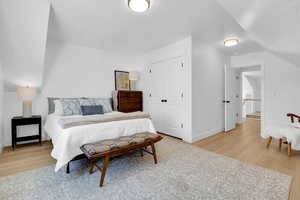 Bedroom with light wood-style flooring and a closet