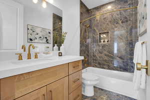 Full bathroom featuring shower / tub combination and vanity