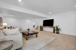 Living room featuring light colored carpet and recessed lighting
