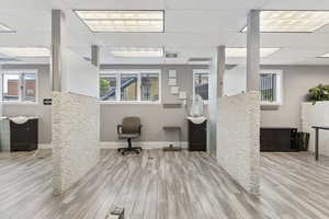 Office featuring a paneled ceiling and plenty of natural light