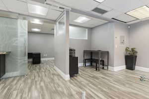 Office space featuring a drop ceiling and electric panel