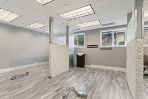 Spare room with light wood-style flooring and a paneled ceiling